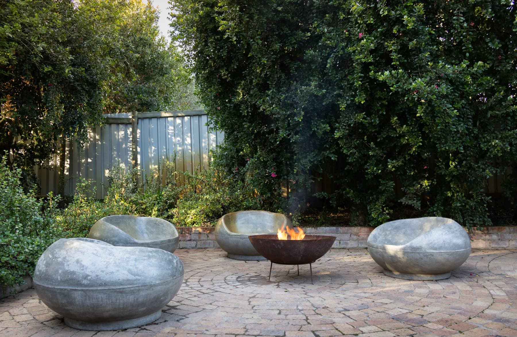 Evening patio with an outdoor fire feature and lounge seating